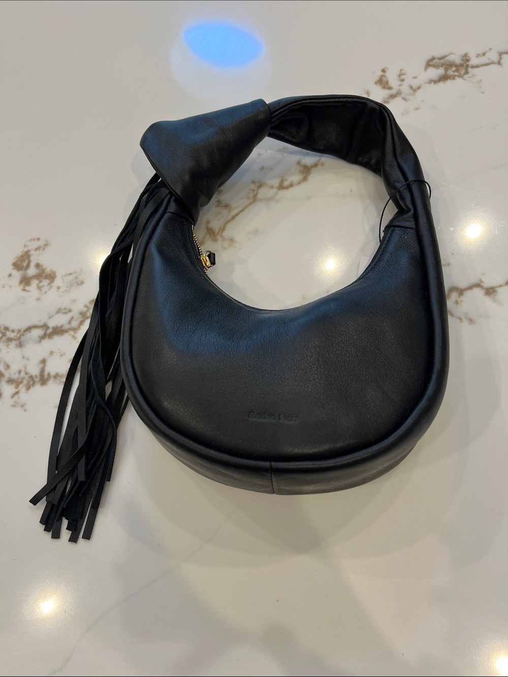 Soft Black Crescent Shoulder Bag with Tassel Accent